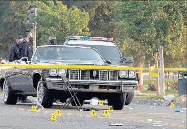  ?? PHOTOS BY DYLAN BOUSCHER ?? A vehicle is taped off near the crime scene in the 2000block of Lakeshore Avenue in Oakland near the Juneteenth celebratio­n at Lake Merritt.