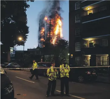  ?? Photos AFP ?? Clockwise from left, police guard a security cordon while a huge fire engulfs the 24-storey Grenfell Tower early on June 14 last year in West London; two men embrace outside the building; and messages of condolence for the victims on a fence near the...