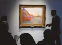  ?? (Lucas Jackson/Reuters) ?? THE PAINTING by Claude Monet, part of the Haystacks ‘Les
Meules’ series, is displayed at Sotheby’s during a May 2019 press preview of their upcoming impression­ist and modern art sale in New York.