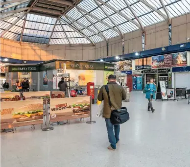  ?? ALAMY. ?? Shops and cafes in the main concourse at Reading station, on March 25. If Network Rail sells non-railway assets, NR-leased businesses that sit within station areas will pass from railway control, warns a RAIL reader.
