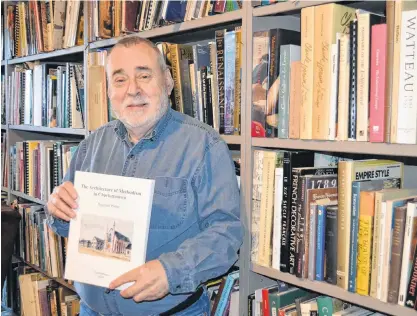  ?? SALLY COLE/THE GUARDIAN ?? Reg Porter holds a copy of his new book, “The Architectu­re of Methodism in Charlottet­own”, in the library of his Belle River home. The P.E.I. art historian will speak on Sunday, Nov. 24, 10:30 a.m., at the 155th anniversar­y service of Trinity United Church in Charlottet­own.