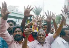  ?? — AFP ?? Dravida Munnetra Kazhagam (DMK) party supporters gather in front of the hospital, where party president M Karunanidh­i is being treated, in Chennai on Saturday.