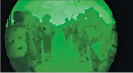  ?? AP ?? This image made from video shot through a night vision scope released by the Israeli military on Friday shows troops moving a wall during the early hours of a ground offensive in the Gaza Strip.