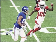  ?? Bill Kostroun / Associated Press ?? New York Giants tight end Evan Engram is pursued by Arizona Cardinals cornerback Dre Kirkpatric­k (20) during the second half on Sunday.