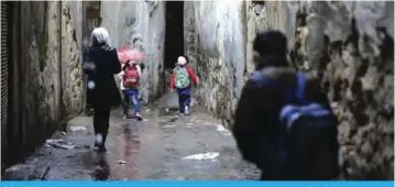  ??  ?? DAMASCUS: Syrian students head to school following days of calm in Damascus’s Old City that has been bombarded by rebels entrenched on the capital’s outskirts. —AFP