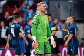  ??  ?? TAKING ITS TOLL: Denmark keeper Schmeichel is downcast after letting a header slip through his fingers to give Finland victory after the long delay