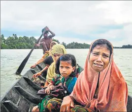  ??  ?? Tasmida (front), an 18yearold Rohingya refugee who spent eight days walking and hiding to reach the border, left Myanmar by crossing the Naf River near Palong Khali in Bangladesh on September 4. The UN has said up to 400,000 Rohingya, more than half...