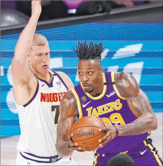  ?? Mark J. Terrill The Associated Press ?? Los Angeles Lakers center Dwight Howard drives against Denver’s Mason Plumlee on Saturday.