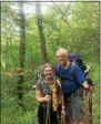  ??  ?? Kim Miller, left, and husband TomWarren pose on the Appalachia­n Trail last spring. Warren admitted the cold nights in the mountains along the trail are easier to take with his wife along with him.