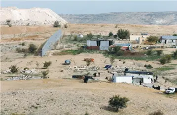  ??  ?? ISRAELI POLICE and Beduin residents are seen following clashes in Umm al-Hiran last year.