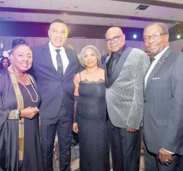  ?? ?? Prime Minister Andrew Holness (second left) poses with Olivia ‘Babsy’ Grange (left), minister of culture, gender, entertainm­ent and sport; Carmen and Edmund Bartlett, minister of tourism, and Ambassador N. Nickolas Perry (right), United States ambassador to Jamaica, at the Bartletts’ 50th wedding anniversar­y held at Royalton Negril Resort Spa in Hanover on Friday.