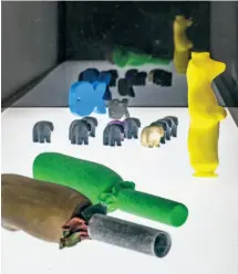  ??  ?? BELOW LEFT 3D-printed objects alongside the historic artifacts they were sourced from. The yellow bear is a replica of an object in the collection of the Anchorage Museum