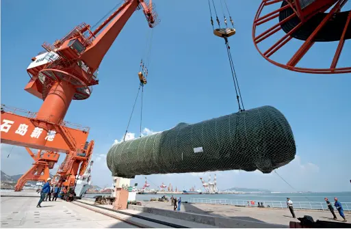  ??  ?? Le 22 septembre 2016, au nouveau port de Shidao, à Rongcheng dans le Shandong, 19 citernes de stockage pétrochimi­que de 50 tonnes sont placées à bord d’un bateau à destinatio­n du Pakistan. Ce sont les premières commandes de Rongcheng dans le cadre des...