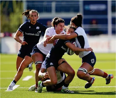  ?? ?? Rhona Lloyd is tackled by Axelle Bethoumieu and Manae Feleu at The Hive yesterday