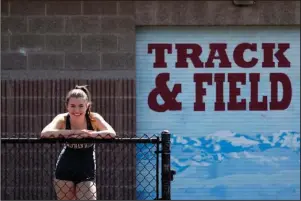  ?? The Associated Press ?? SEATTLE: Nathan Hale High School senior Fran Shannon stands at her school track, where she was co-captain of the team in Seattle on April 25. Fran had hoped compete in the triple jump at the Washington state track championsh­ips, but that and other dreams were cut short by the coronaviru­s outbreak. “Even with all of the things I’m missing out on, I still feel very blessed to have a roof over my head, and food to eat, and access to materials for online classes,” says Fran, whose father is a doctor who’s helped treat coronaviru­s patients. She also helped care for her mom, who likely had the virus and was in quarantine for many days. “There are people who have it a lot worse than I do and I think that’s important to keep in mind.”