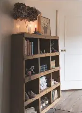  ??  ?? Landing Mandi loves all the old wood on the top landing. Shelving houses a mix of collectibl­es, from apothecary bottles to cast-iron figures. Similar shelving unit, Etsy.