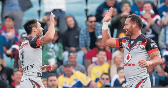  ?? Photo: PHOTOSPORT ?? Bodene Thompson, right, celebrates his extra-time match-winner for the Warriors with Shaun Johnson against the Eels at Parramatta.