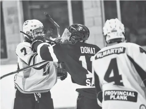  ?? [FAISAL ALI / THE OBSERVER] ?? Wellesley’s Drew Mullett scraps with the Braves during game action Nov. 23 in Tavistock, the first of a home-and-home series that saw the Jacks come up emptyhande­d.