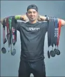  ?? SANCHIT KHANNA/HT PHOTO ?? Amit Kadian poses with his haul of medals.