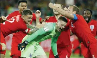  ?? VICTOR R. CAIVANO — THE ASSOCIATED PRESS ?? England’s Harry Kane, right, goalkeeper Jordan Pickford, center, and Kieran Trippier celebrate with teammates after beating Colombia in Moscow in a shootout.