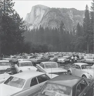  ?? Rondal Partridge
Autr y National Center ?? REVEALING HUMANITY’S ENCROACHME­NTS In “Pave It and Paint It Green,” Partridge showed Yosemite’s Half Dome and a crowded park
ing lot, instead of a pristine vista typical of his celebrated mentor, Ansel Adams.