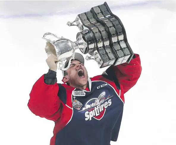  ?? — POSTMEDIA NEWS FILES ?? Canucks goaltendin­g prospect Michael DiPietro hoists the Memorial Cup after his Windsor Spitfires beat the Erie Otters to win the junior championsh­ip back in May. DiPietro’s athletic ability and dramatic flair make him fun to watch, writes Jason...