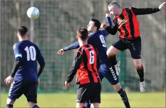  ??  ?? Bellurgan’s Diarmuid Murphy heads forward as Darryn Gaynor challenges for Ardee Celtic.