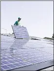  ??  ?? In this file photo, a worker is seen installing solar panels nearly 4.9 million homes are powered by solar energy in California and the number is expected to continue to grow, according to the Solar Energy Industries Associatio­n,
a non-profit trade...