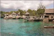  ?? ROBERT RAUSCH/THE NEW YORK TIMES ?? A swimmer floats offshore in Negril, Jamaica, in 2016. For now, non-business travelers to Jamaica are restricted to a “Resilient Corridor” along the north coast, from Negril to Portland.