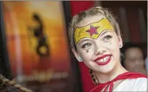  ?? DEBORAH CANNON / AMERICAN-STATESMAN ?? Sylvia Grimes, 12, wore a Wonder Woman costume Tuesday as she attended one of the two females-only showings at the Alamo Drafthouse Ritz of “Wonder Woman,” a new film featuring the comic-book superheroi­ne.