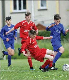  ??  ?? Arrow Harps and Merville United players in action.