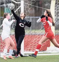  ?? Arnold Gold / Hearst Connecticu­t Media ?? Cheshire goalie Seymone Rosenberg, center, blocks a shot in the first half against New Canaan on Nov. 14 in a Class LL tournament game in Cheshire. At left is Courtney O’Connell of New Canaan and at right is Ella Crerar of Cheshire.