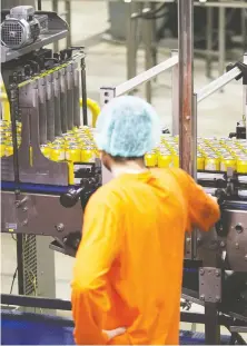  ?? DELLA ROLLINS/ BLOOMBERG ?? A worker inspects beer cans as they move along a conveyor at the Waterloo Brewing Ltd. brewery in Waterloo, Ont. In the next two years, the company plans to more than double the volume of beverages it's producing for other brands to 650,000 hectolitre­s.