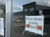  ??  ?? A sign on a business in Tenino, Wash,. says they will be accepting wooden money on May 21.