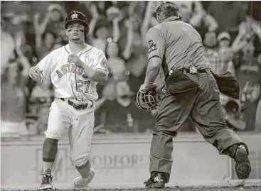  ?? Yi-Chin Lee / Houston Chronicle ?? The Astros’ Jose Altuve, who tested the arm of Red Sox left fielder Andrew Benintendi while trying to score the tying run on Carlos Beltran’s eighth-inning single, is called out at the plate by umpire Greg Gibson.