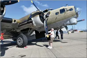  ?? Photo by Michael Derr ?? A volunteer prepares a propeller on a B-17 Flying Fortress during “The Wings of Freedom Tour” stop at Quonset State Airport in North Kingstown on Sept. 13. The same plane crashed on Wednesday in Hartford, Conn., killing seven people. The bomber, nicknamed “Nine O Nine,” also made many appearance­s at North Central State Airport in Lincoln during previous tours.