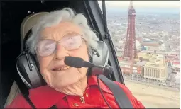  ??  ?? Beaming Olive soars over Blackpool Tower on her birthday trip