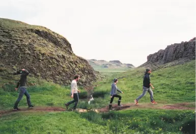  ?? Under the Milky Way ?? Co-director Mélanie Laurent (second from right) and members of her film crew trudge single file from location to location in making their documentar­y on the environmen­t.