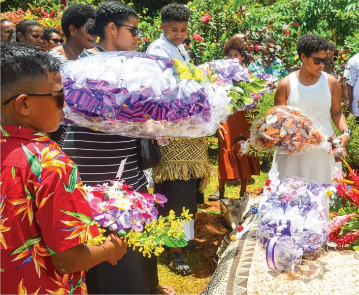 ?? ?? Family members of the late Lemeki Savua during the funeral in Savusavu. Photos: Matata Production