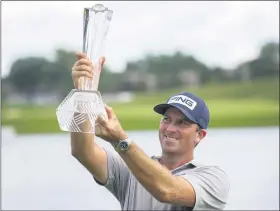  ?? ANDY CLAYTON-KING — THE ASSOCIATED PRESS ?? Michael Thompson holds the trophy after winning the 3M Open on July 26.