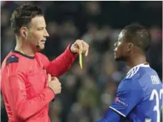  ??  ?? SEVILLE: This is a Nov. 22, 2016 file photo of English referee Mark Clattenbur­g of Britain as he shows a yellow card to Juventus’ Patrice Evra during the Group H Champions League soccer match between Sevilla and Juventus at the Ramon Sanchez-Pizjuan...