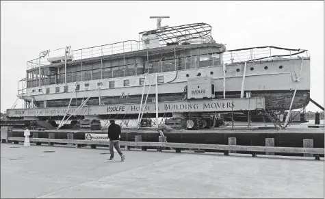  ?? SEAN D. ELLIOT/THE DAY ?? The former presidenti­al yacht Sequoia, built in 1925, sits at City Pier in New London on a barge Wednesday. It’s on the way to Maine for restoratio­n.