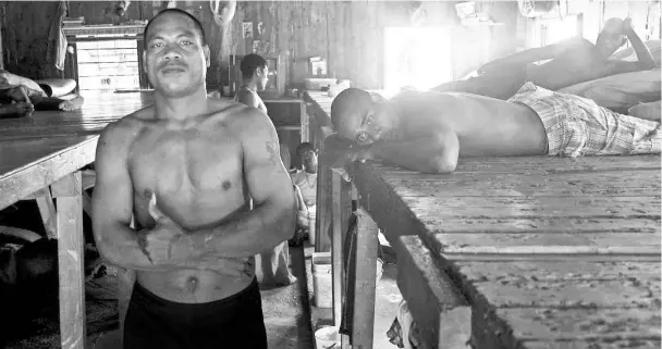  ??  ?? Prisoner Maruai (left), stands next to inmates inside the sleeping dormitory of a prison located on the island.