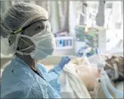  ?? Irfan Khan Los Angeles Times ?? NURSE Jeanette Pimentel with a COVID-19 patient at Paradise Valley Hospital in National City, Calif. The pandemic has overwhelme­d hospitals.