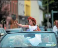  ?? TANIA BARRICKLO — DAILY FREEMAN ?? Poppy Queen Isabella Winegard, 7, daughter of Mara and Daniel Winegard of Stone Ridge, throws out candy as she rides up Broadway at the Kingston Memorial Day Parade on Monday.