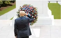  ?? ANNA MONEYMAKER/THE NEW YORK TIMES ?? President Donald Trump salutes during a Memorial Day event Monday at the Tomb of the Unknown Soldier at Arlington National Cemetery.