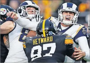  ?? [KEITH SRAKOCIC/THE ASSOCIATED PRSS] ?? Rams quarterbac­k Jared Goff, right, is hit by the Steelers’ Cameron Heyward during last Sunday’s game in Pittsburgh.
