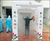  ?? WASEEM ANDRABI/HT ?? A visitor walks through a sanitising chamber at a hospital in Srinagar on Thursday.