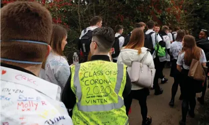  ?? Photograph: Adrian Dennis/AFP/Getty Images ?? Year 11 pupils, some with graffiti-covered shirts, leaving school unexpected­ly earlier this year as schools began to close.