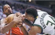  ?? JEFFREY PHELPS / AP ?? Milwaukee Bucks’ Giannis Antetokoun­mpo fights for a rebound with Houston’s Trevor Ariza during the second half of Monday’s 127-114 triumph over the Rockets.